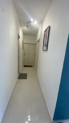 a hallway with white walls and a white tile floor at Nice apartment close to the Marbella beach in Cartagena de Indias