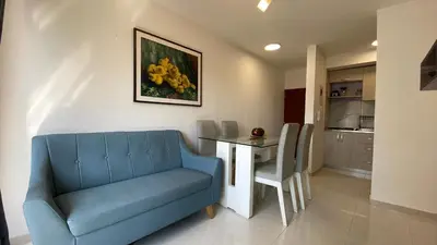 a living room with a blue couch and a table at Nice apartment close to the Marbella beach in Cartagena de Indias