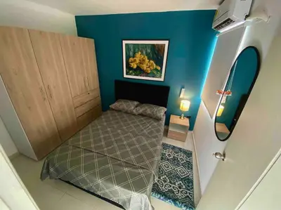 a small room with a bed and a blue wall at Nice apartment close to the Marbella beach in Cartagena de Indias