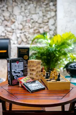 a table with a chess game and books on it at Cartagena Suites de Manga in Cartagena de Indias