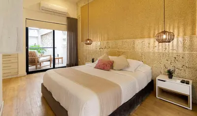 a bedroom with a large bed and a balcony at Cartagena Suites de Manga in Cartagena de Indias