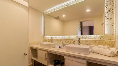 a bathroom with two sinks and a large mirror at Cartagena Suites de Manga in Cartagena de Indias