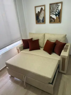 a bedroom with a bed and a couch at REFUGIO URBANO - Apartamento para descanso y trabajo remoto en Alameda del Río Barranquilla in Barranquilla
