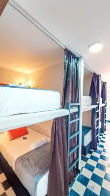a room with two bunk beds and a checkered floor at Hostel Dorado Plaza Getsemaní in Cartagena de Indias