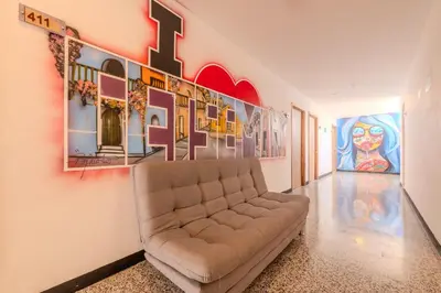 a living room with a couch and paintings on the wall at Hostel Dorado Plaza Getsemaní in Cartagena de Indias