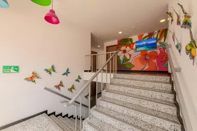 a staircase in a house with a painting on the wall at Hostel Dorado Plaza Getsemaní in Cartagena de Indias