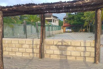 a brick wall with a gate and a fence at Cabaña Lilimar. in La Perdiz