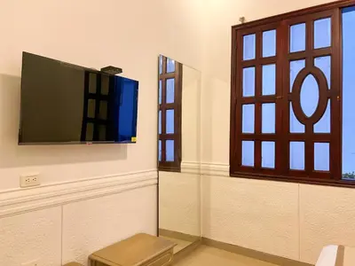 a room with a flat screen tv on a wall at Hotel Barranquilla Prado in Barranquilla