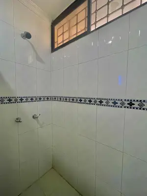 a bathroom with a shower with white tiles at APARTAMENTO CATALINA BOCAGRANDE 1b in Cartagena de Indias
