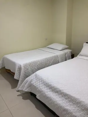 two beds sitting next to each other in a room at APARTAMENTO CATALINA BOCAGRANDE 1b in Cartagena de Indias