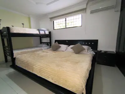 a bedroom with two bunk beds and a window at APARTAMENTO CATALINA BOCAGRANDE 1b in Cartagena de Indias