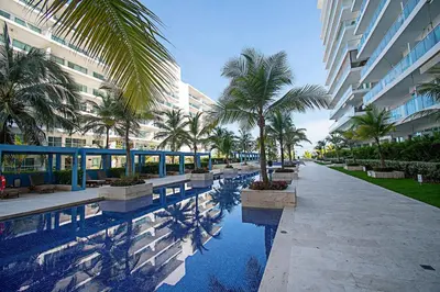 a resort with palm trees and a swimming pool at U-GO Morros Ultra in Cartagena de Indias