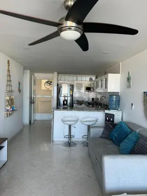 a living room with a couch and a ceiling fan at Perla Santa - Luxury Condo in Santa Marta