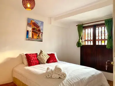 a bedroom with a bed with towels on it at Gorgeous 8 BR House w/ Pool in the Old City in Cartagena de Indias