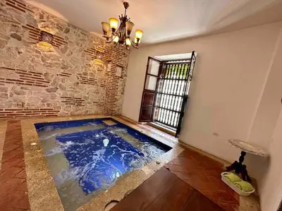 a room with a swimming pool in the middle of a room at Gorgeous 8 BR House w/ Pool in the Old City in Cartagena de Indias