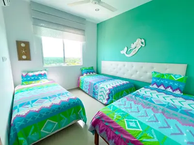 a bedroom with two beds and a window at Magico Apartamento Frente al Mar 3 Habitaciones PV81 in Coveñas