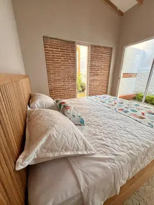a bedroom with a large bed with a window at Colonial Beach Airport Hotel in Cartagena de Indias