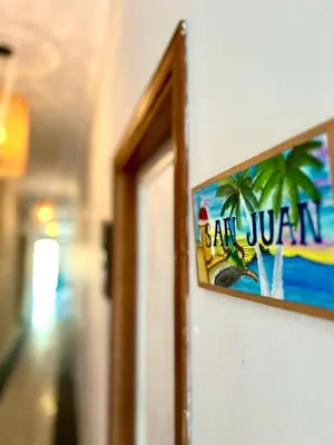 a picture of a sign hanging on a wall at Colonial Beach Airport Hotel in Cartagena de Indias