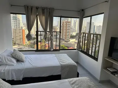 a bedroom with two beds and a large window at BARLOVENTO in Cartagena de Indias