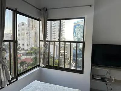 a bedroom with a large window with a view of a city at BARLOVENTO in Cartagena de Indias