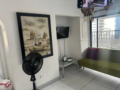 a living room with a fan and a window at BARLOVENTO in Cartagena de Indias