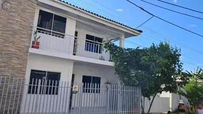 a white house with a white fence in front of it at Piantini Houses in Coveñas