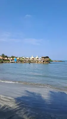 a body of water with houses in the background at Piantini Houses in Coveñas