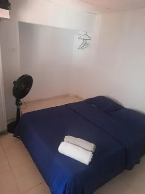 a bedroom with a blue bed with two towels on it at Casa Tamarielys 3 Habitaciones in Cartagena de Indias