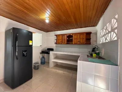 a kitchen with a refrigerator and a wooden ceiling at Casa Tamarielys 3 Habitaciones in Cartagena de Indias