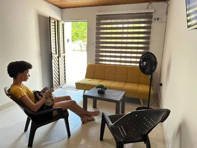 a woman sitting in a chair in a living room at Casa Tamarielys 3 Habitaciones in Cartagena de Indias