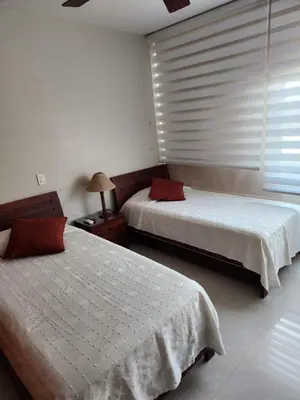 a bedroom with two beds and a window with blinds at Apartamento con terraza Frente al Mar in Cartagena de Indias