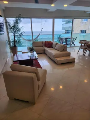 a large living room with couches and a table at Apartamento con terraza Frente al Mar in Cartagena de Indias