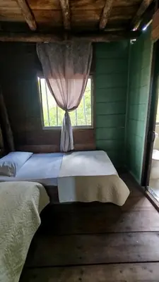 a bedroom with two beds and a window at Mi Cabañita Guest House in Playa Blanca