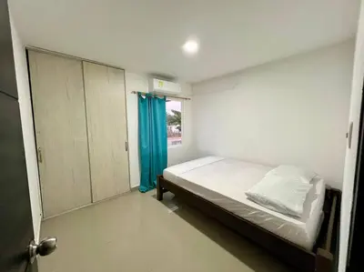a small bedroom with a bed and a window at Tu lugar ideal cerca al mar apartamento MyM in Coveñas