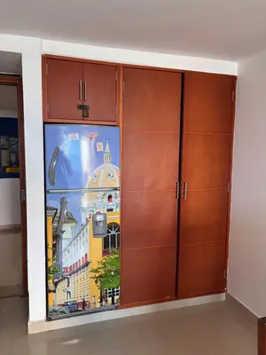 a large wooden cabinet in a room with a window at Fabuloso estudio con vista al laguito in Cartagena de Indias