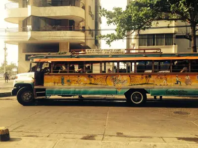 an old bus is parked on a city street at Fabuloso estudio con vista al laguito in Cartagena de Indias