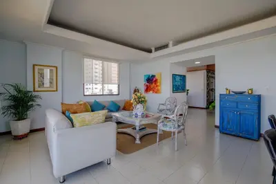 a living room with a couch and a table at Amplia habitación con vista al mar y baño privado in Cartagena de Indias
