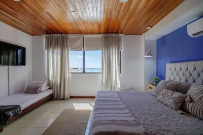 a bedroom with a large bed and a window at Amplia habitación con vista al mar y baño privado in Cartagena de Indias