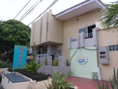 a building with a sign in front of it at Hotel Casa Boston Inn by Finerh in Barranquilla