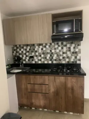 a kitchen with a stove and a microwave at Apartamento en la Boquilla in Cartagena de Indias