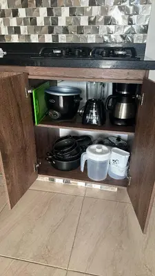 a shelf with pots and pans and other kitchen items at Apartamento en la Boquilla in Cartagena de Indias