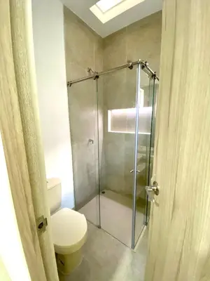a bathroom with a toilet and a glass shower at Guakmaya hostel in Cartagena de Indias
