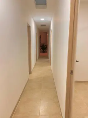 a hallway with white walls and a tile floor at Guakmaya hostel in Cartagena de Indias