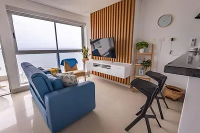 a living room with a blue couch and a tv at COMFORTABLE DEPARTAMENT IN FRONT THE SEA in Cartagena de Indias