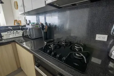 a black stove top oven in a kitchen at COMFORTABLE DEPARTAMENT IN FRONT THE SEA in Cartagena de Indias