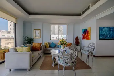 a living room with a couch and a table and chairs at Habitación doble baño privado cerca al mar y bahia in Cartagena de Indias