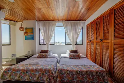 a bedroom with two beds and a window at Habitación para 3 a una cuadra de la playa y bahía in Cartagena de Indias