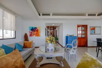 a living room with a couch and a table at Habitación para 3 a una cuadra de la playa y bahía in Cartagena de Indias