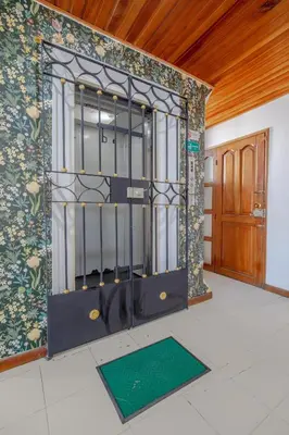 an iron gate in a room with a door at Habitación para 3 a una cuadra de la playa y bahía in Cartagena de Indias