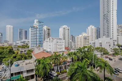 a city skyline with tall buildings and palm trees at Habitación para 3 a una cuadra de la playa y bahía in Cartagena de Indias